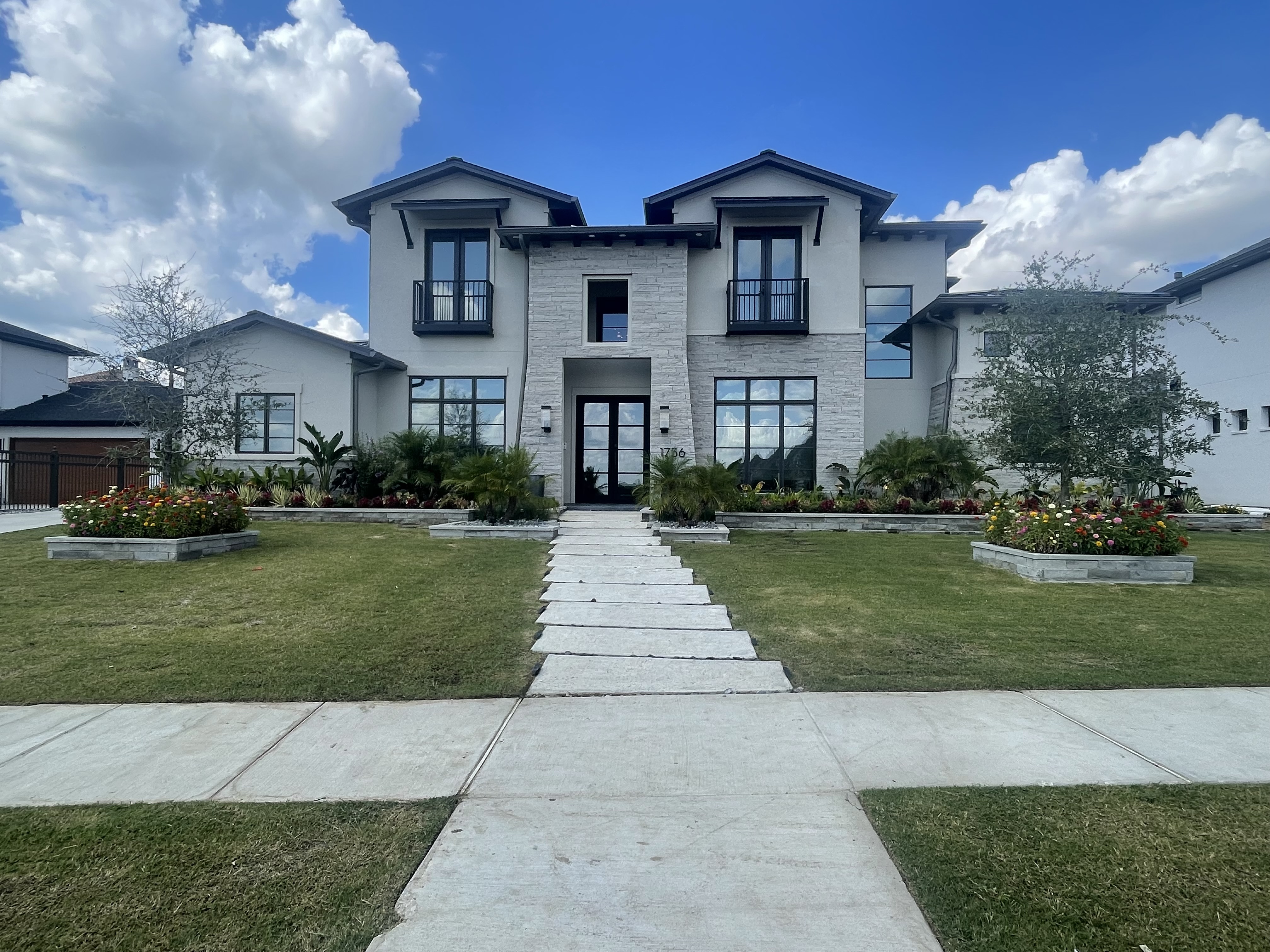 Modern home with tinted windows and landscaped front pathway