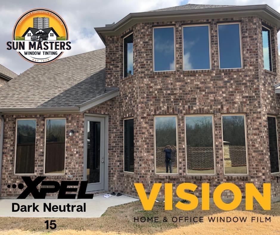 Brick home with XPEL Vision Dark Neutral 15 window film installed by Sun Masters
