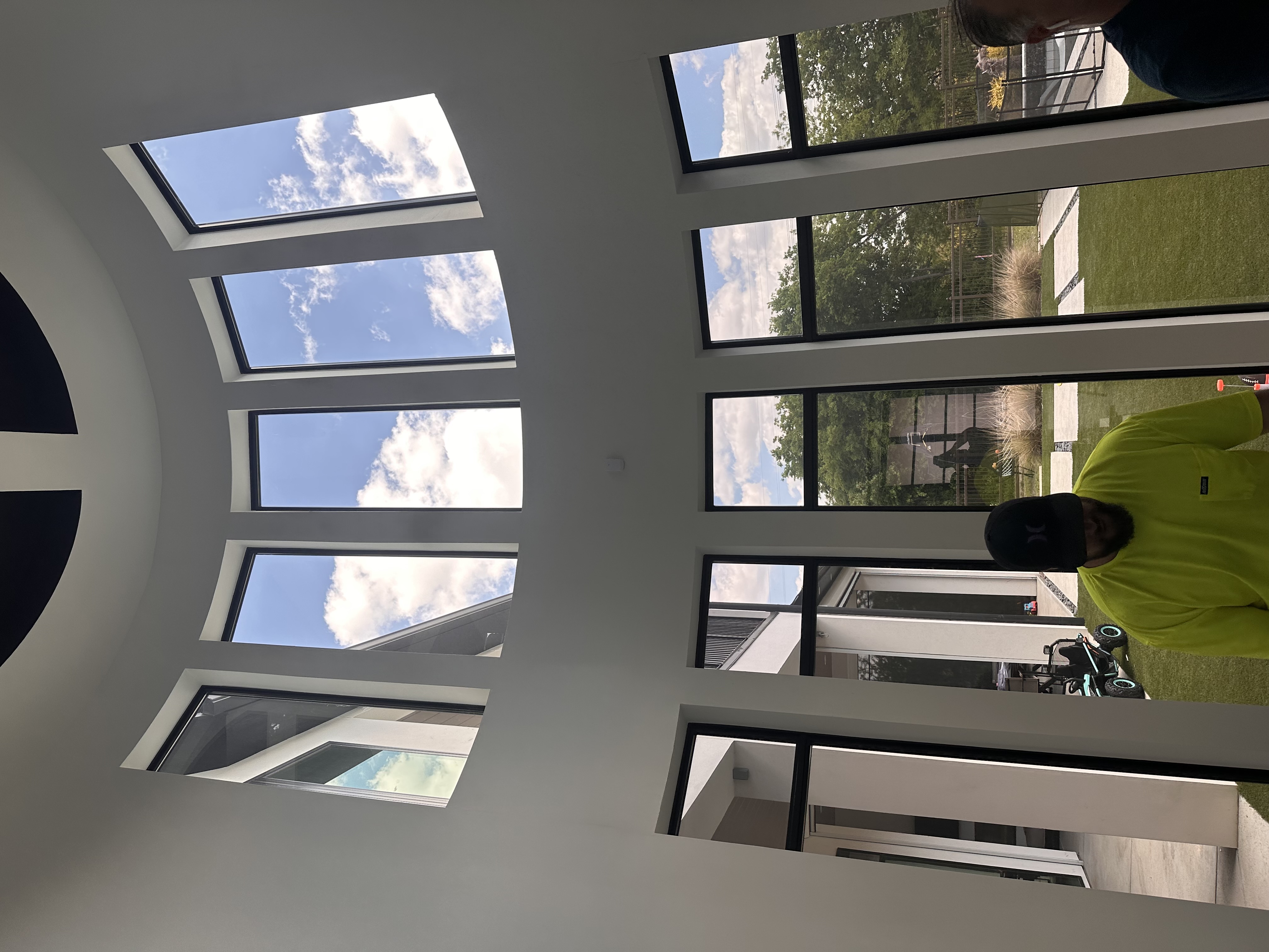 Modern home interior with high skylights and tall tinted windows